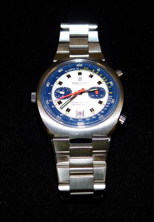 BREITLING MAN'S WRISTWATCH: Trans-Ocean Chrono-Matic model, automatic date chronograph with minute and hour registers, silvered dial with blue tachymeter and pulsometer scales, orange sweep and seconds, stainless steel water res