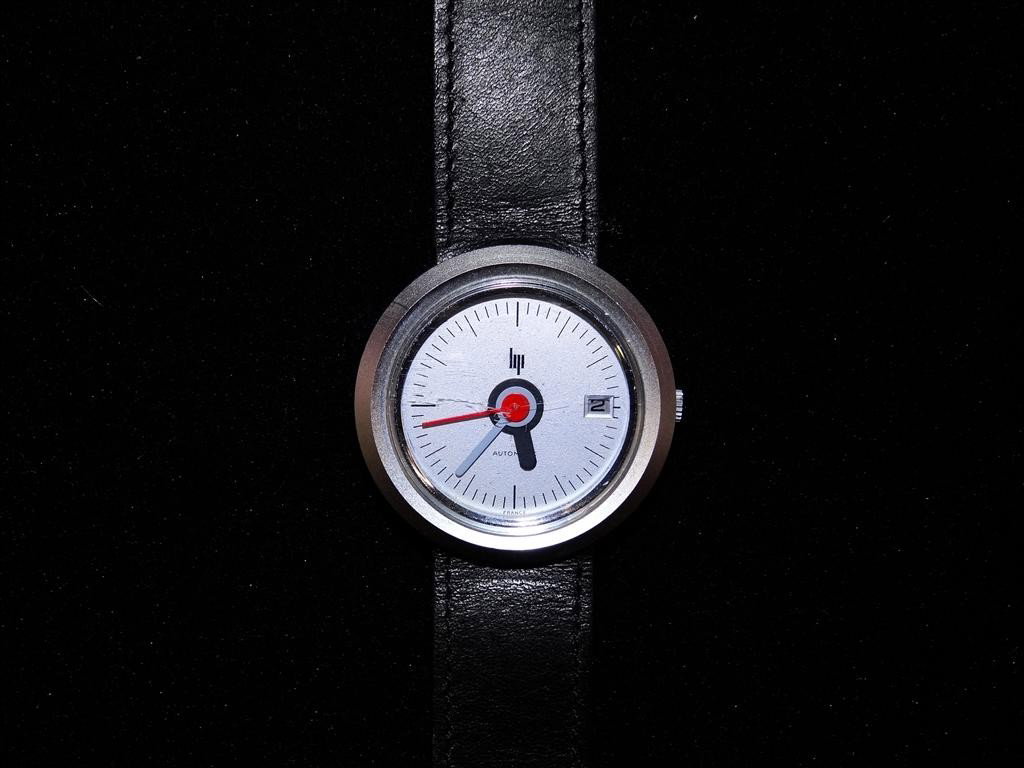 LIP AUTOMATIC MAN'S WRISTWATCH: Date model with TGV hands (Roger Tallon was the designer of the "Train Grand Vitesse," and one see such hands in European train stations), steel case, leather band, 37mm