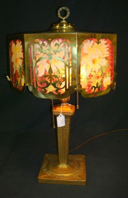 PAIRPOINT REVERSE PAINTED PANEL LAMP: Brass octagonal shade with reverse painted panels, floral decorated (one panel is cracked Signed on the base. 23"H. 14"D. shade