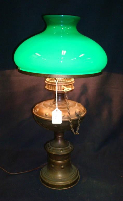 BRASS HURRICANE LAMP EMERALITE SHADE: Cased glass emeralite shade on a brass urn shaped oil lamp base. 21 1/2"H. 11"D