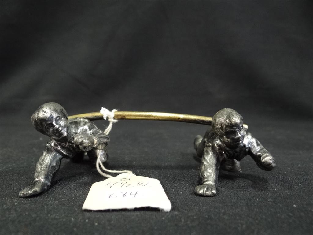 AMERICAN VICTORIAN FIGURAL KNIFE REST: Crawling Kate Greenaway boys support the knife rest.