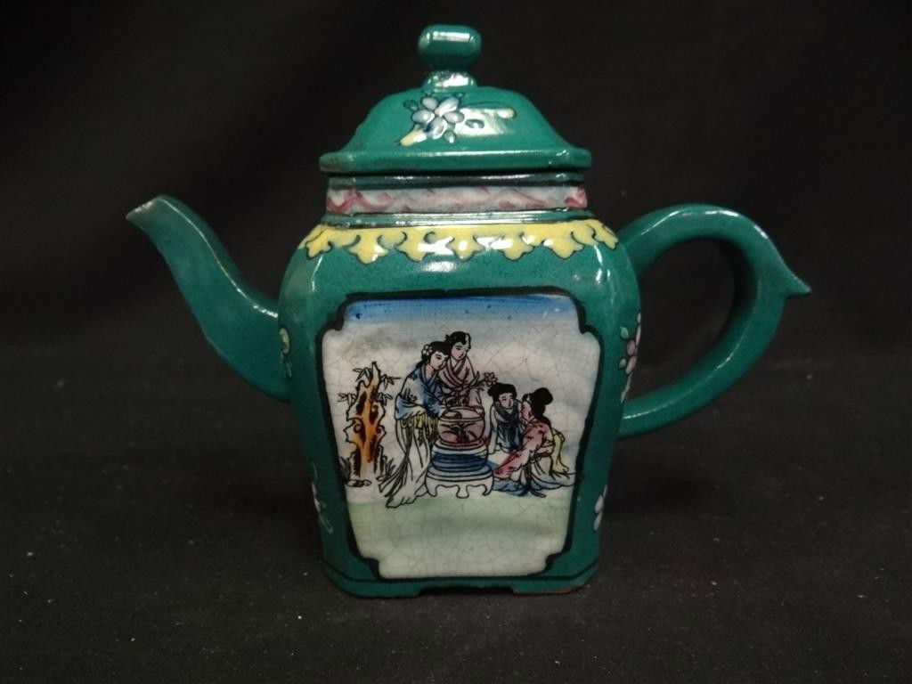 CHINESE REDWARE TEAPOT: Green glaze with handpainted decorations of a family and mother bathing a child. Signed at the base. 8 /2" W. x 6 3/4"H