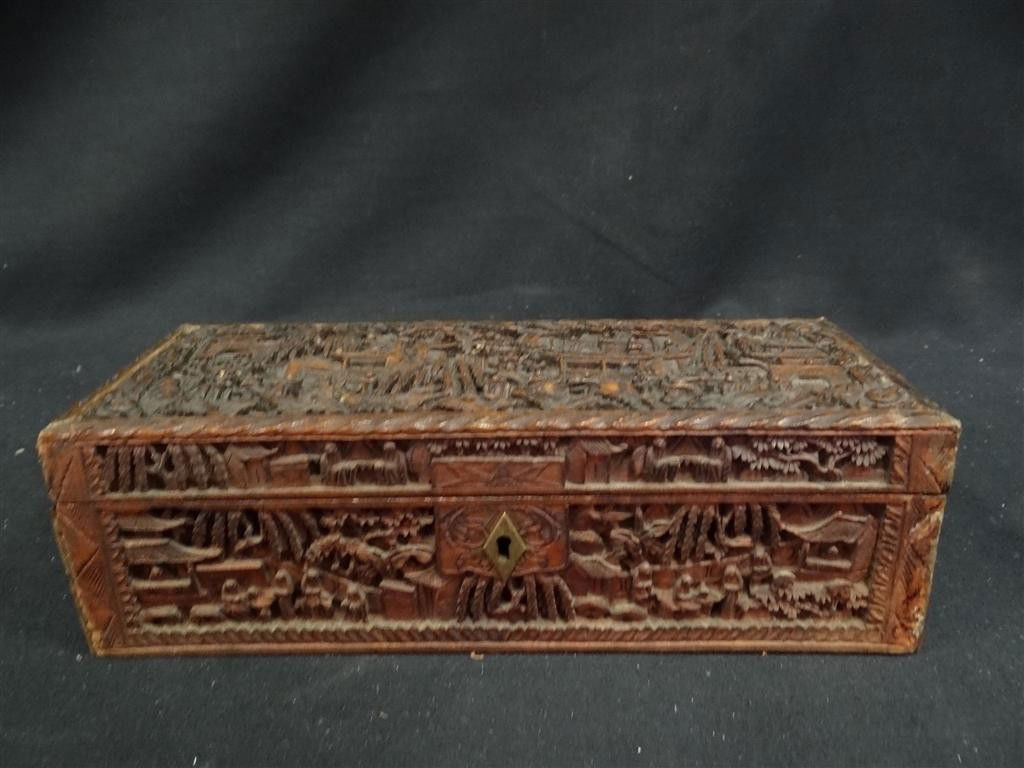 CARVED CHINESE WOODEN BOX: Elaborately carved Chinese wooden box. Carved with village scenes with figures. 9 3/4" x 3 3/4" x 2 1/4"W