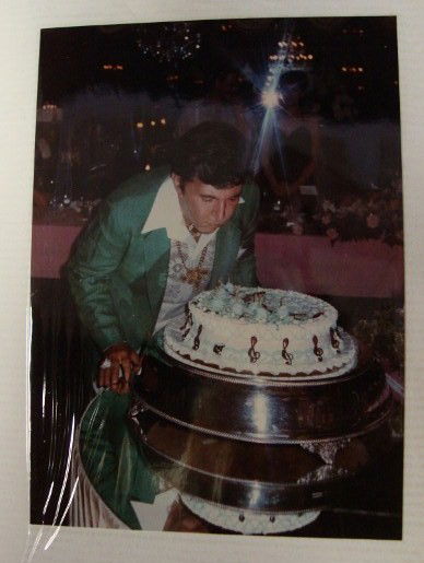 LIBERACE PERSONAL PHOTO ALBUM: Three ring blue photo album with personal photos including Liberace with birthday cake. There are original photographs of many friends and family. Liberace is shown with Lionel Richee; Cary James is p