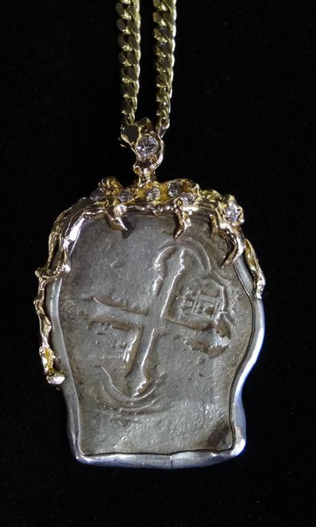 15TH C. SILVER DOUBLOON W/18K GOLD & DIAMONDS: 15th century Spanish Doubloon mounted in 18K gold with approximatly 1.0 ct of exceptional diamonds. Colorless-V VS1 - V VS2 clarity on 20" 14K gold link chain. A Liberace novelty. 2.26 oz / 63.8 grams