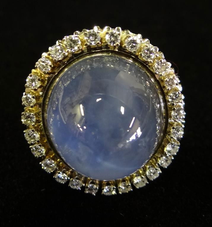 14K GOLD SAPPHIRE & DIAMOND RING: 14K white gold light blue sapphire ring with a 28 diamond surround. A Liberace favorite worn frequently during stage performances and in private. Heavy weight. A gift to Liberace from Sammy Davis Jr.