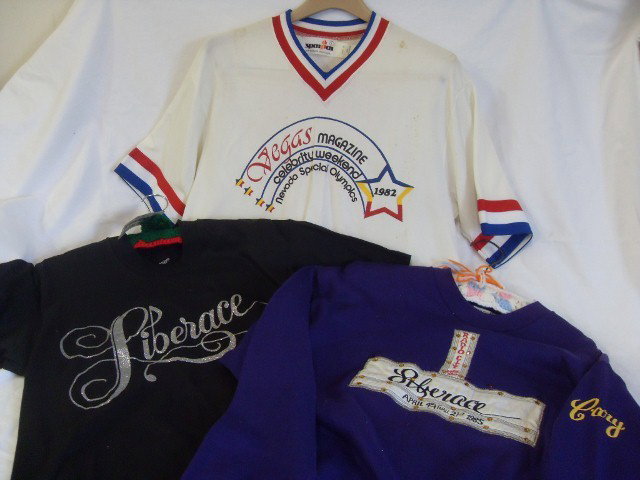 THREE LIBERACE & CARY JAMES FUN SHIRTS: Never worn Liberace "Diamond Dust" tee shirt, L. size; Russell Athletic L size Liberace Sweatshirt made for his entourage, this one embroidered Radio City Music Hall, April 4th thur 21st, 1985 and wit