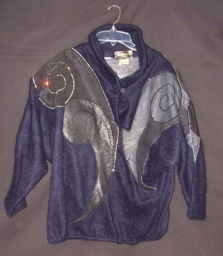 LIBERACE'S ROBERTO CAVALLI JACKET: Mohair and special effects leather. Midnight blue. Pierced work leather and sequin decorated. Abstract segments. Pull over one button style. Size small. Label reads, Roberto Cavalli Firenze, Made in I