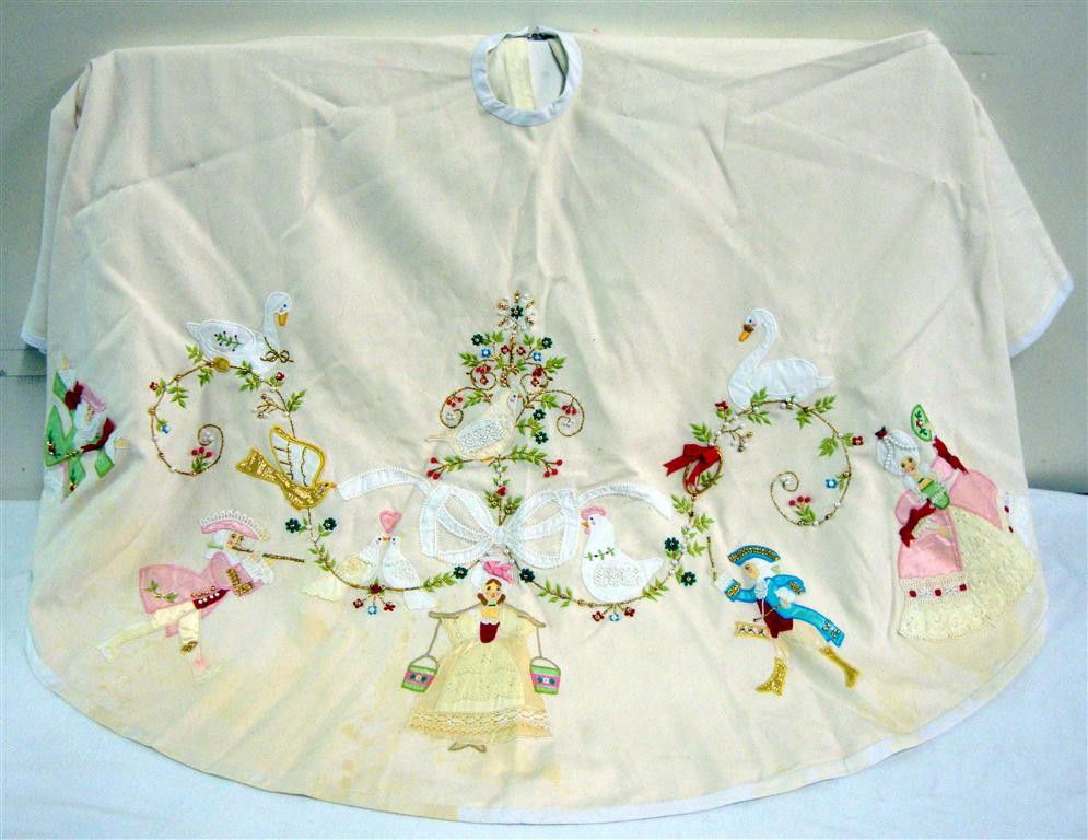 LIBERACE'S CHRISTMAS TREE SKIRT: Ornate lace and openwork applications depict fanciful figures. Pearl, gold and other beads create flower stamens on the vines.