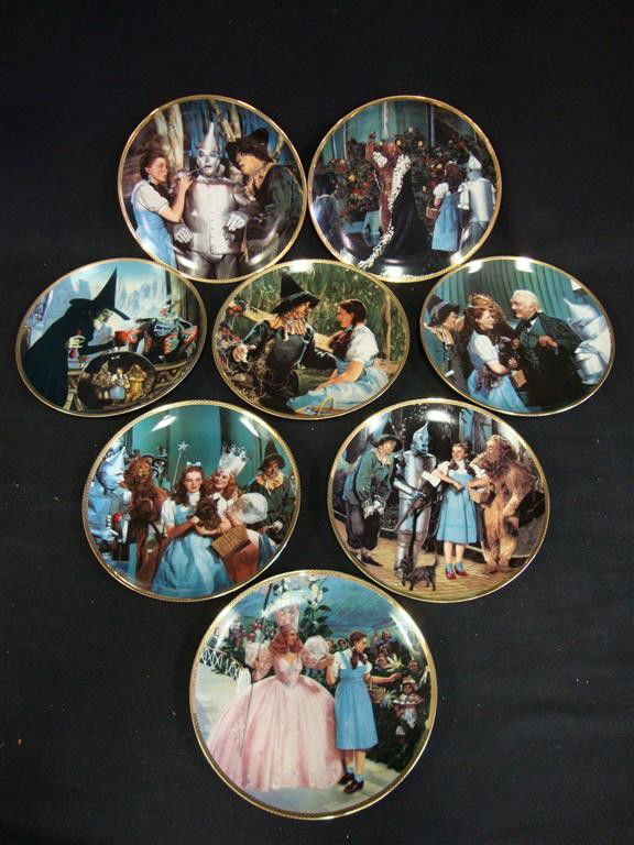 LIBERACE'S WIZARD OF OZ PLATES (8): The Hamilton Collection. Rimmed in 23K gold. The porcelain plates are a tribute to the 1939 classic movie. In original packaging and boxes, with accompanying papers. Eight are in the lot. Witch Casts