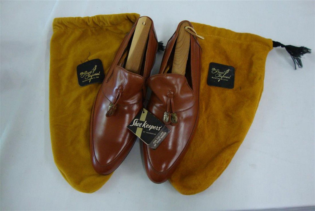 LIBERACE'S PLAYBOY LOAFERS: Never worn Brazilian leather loafers with the playboy cloth label at the inside. Tassels have gilt ornamentation with Playboy logo rabbit heads at the center in velvet shoe bags.
