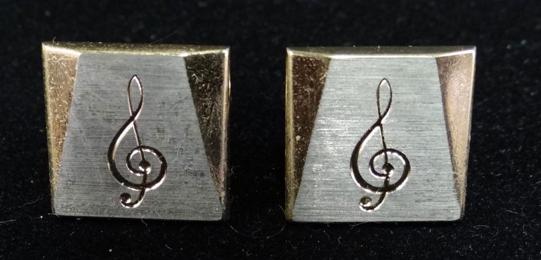 LIBERACE'S TREBLE CLEF CUFF LINKS: Two tone silver and gold color decorated with musical notes. These cuff links wer epictured in the New York Times article Friday September 16th 2011 about their auction.