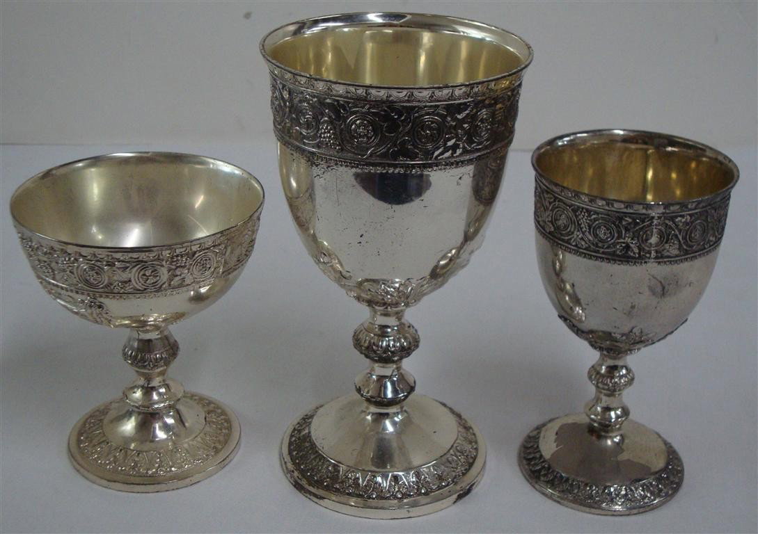 SILVER PLATE GOBLETS-PALM SPRINGS HOUSE: The lot is accompanied by 3 1/2" x 5" candid of Liberace, Christmas, 1982 at the table in Palm Springs. The dogs are participating in the Christmas meal and these goblets are on the table. 5"H, 4"H, 6