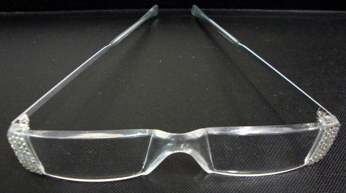 LIBERACE BIFOCAL EYE GLASSES: Pair of bifocal eye glasses with jewels at the corners of lenses marked made is in Germany.