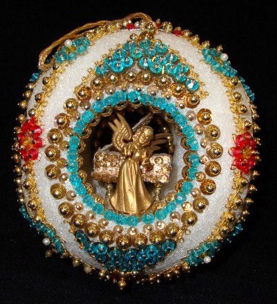 LIBERACE'S CHRISTMAS DECORATIONS INC. A PIANO: Santa decorations (10) A gold lame Santa, santa in sleigh, a traditional Santa, three felt Santa gift tags and four others. Also in the lot is a large beaded and sequinned hand made holiday ball which