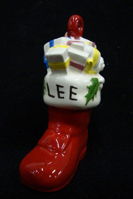 LIBERACE PERSONALIZED BOOT ORNAMENT: Red Santa boot with Lee written in gold paint and at the reverse, the book is marked C.H. & F.H. 1982. Hand made and glazed ceramic boot. (perhaps a gift to Liberace from the Heller children (Seymour