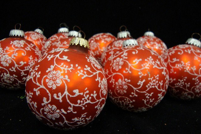 TEN RED GLASS CHRISTMAS BALLS: With white vine and flower glitter decorations. 3 3/4" H.