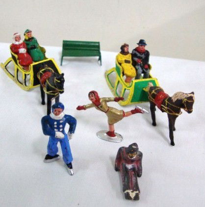 ANTIQUE HOLIDAY LEAD FIGURES: Liberace's collection of antique winter/holiday lead figures. Seven figures including 4 seated in carriage, two skaters and another; two horses pulling carriages; and a green painted park bench. All h