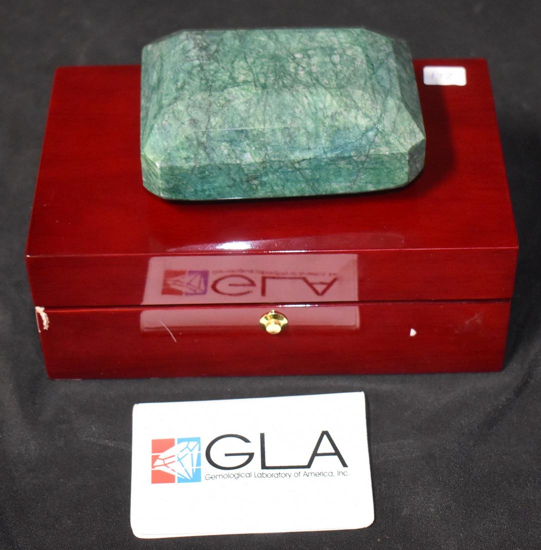 5395 Carat Emerald (Beryl) Composite: Emerald (beryl) composite, 5,395 carats, 119.85mm x 86.17mm x 51.02mm. Gemological Laboratory of America identification card is included with other information about the emerald. Replacement cost list