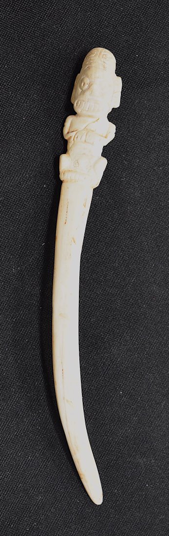 Great Survivor Taino Bone Zemi Vomic: From a manatee rib bone, this tusk quality carving of the seated Zemi is very finely carved. Re-stuck from excavation with now, a rather unobtrusive crack line across the figure's middle. Of abut mid-