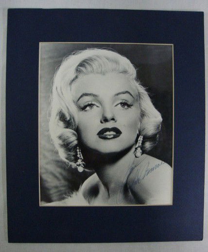 MARILYN MONROE SIGNED PHOTOGRAPH: Glamour head shot signed in blue ink Love, Marilyn Monroe. Matted 7 1/4: x 9" (photo)