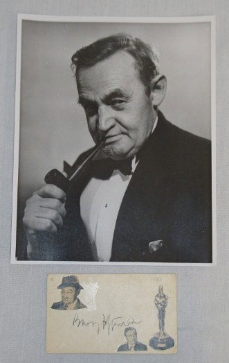 BARRY FITZGERALD AUTOGRAPH AND PORTRAIT: Barry Fitzgerald autograph in black ink on album page collected in 1947. Small photos (20 of the actor and of an Oscar have been affixed. Included in the lot is an 8" x 10" portrait of the star.
