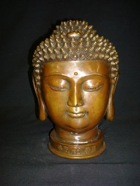 ORIENTAL BRONZE HEAD OF A BUDDHA: Heavily chaised design with calligraphy at base, signed; 10in. H.