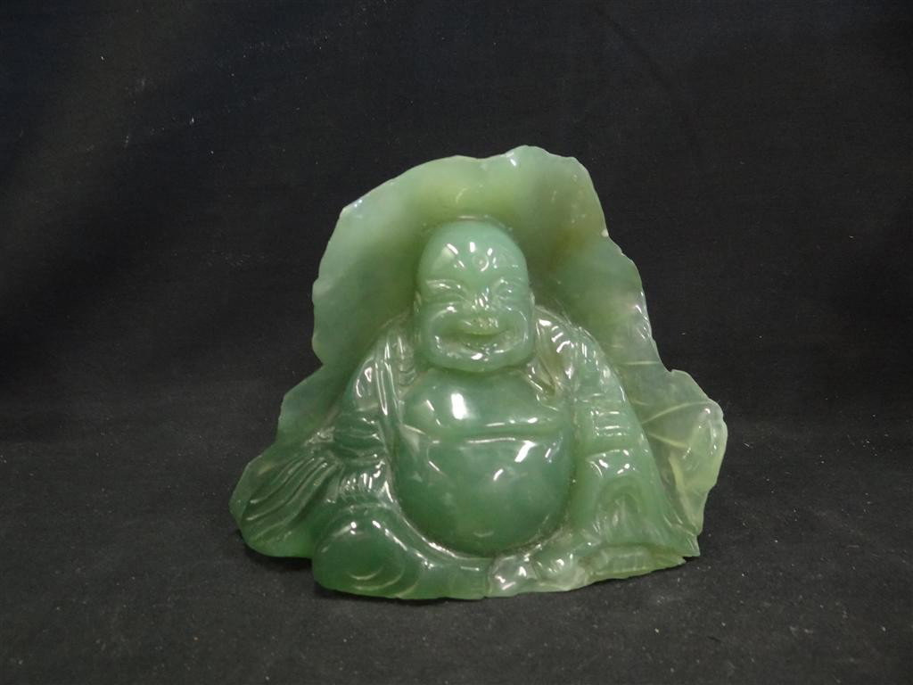 MOSS GREEN JADE BUDDA: Seated in a large leaf. 6-1/4" high x 8" wide
