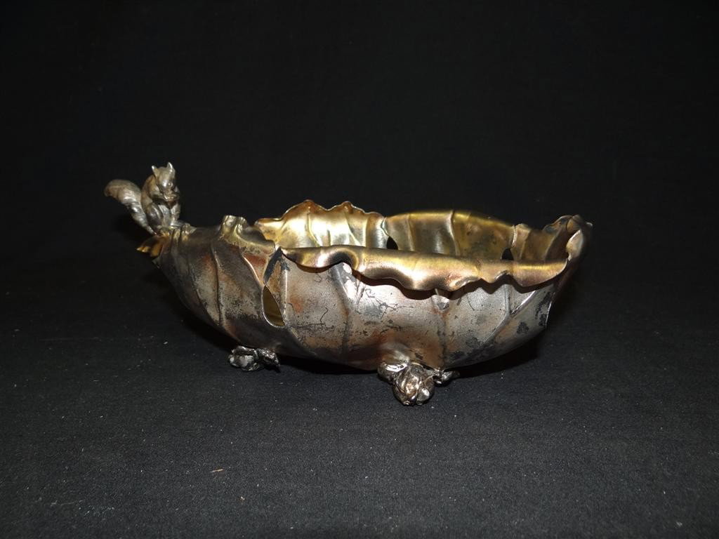 AMERICAN VICTORIAN PAIRPOINT NUT BOWL: Squirrel perched on the edge of the leaf form bowl raised on four feet. Signed Pairpoint Mfg. Co. 11"L