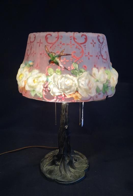 PAIRPOINT CLOSE TOP PUFFY TABLE LAMP: Decorated with roses and humming birds. On a tree trunk base. Signed on the shade and numbered on the base 1602; 24in. H. x 16"D. shade.