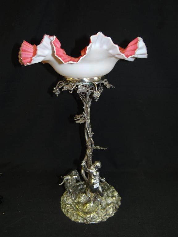 AMERICAN VICTORIAN SILVERPLATE AND SATIN GLASS BOW: Figural girl with goat Silver over bronze The interior of the bowl decorated with multi colored enameling. 19" H. 12" D