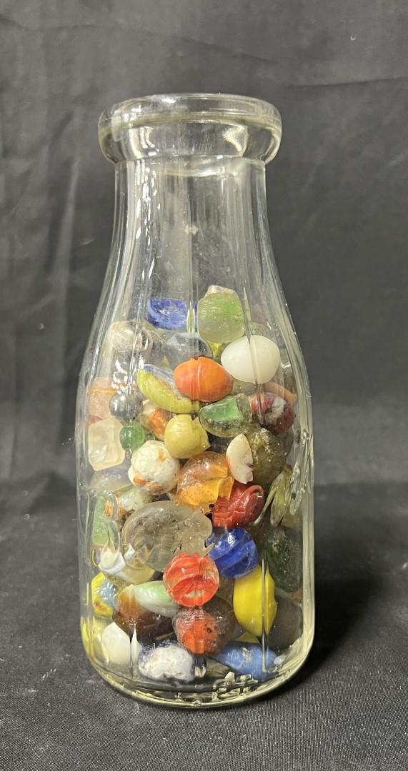 Borden's Bottle of Collectible Marbles: Various colors. Distorted shapes. May be glass remnants of when marbles were being made. Pint bottle