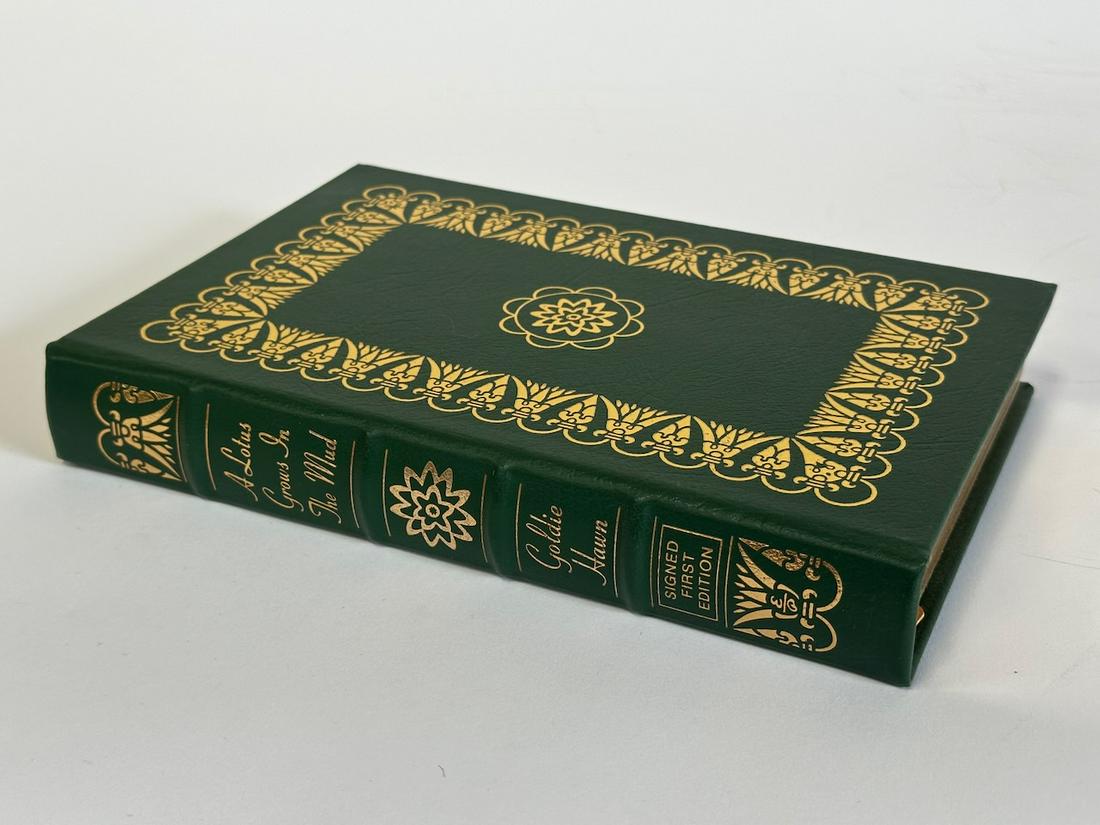 A Lotus Grows In The Mud, Goldie Hawn - Sgd. First Edition; Easton Press: Green leather bound, 2005. Most books in this collection are in Unused Condition. Some have minor flaws from sitting on book shelves that we'll show when photographing if significant enough.
