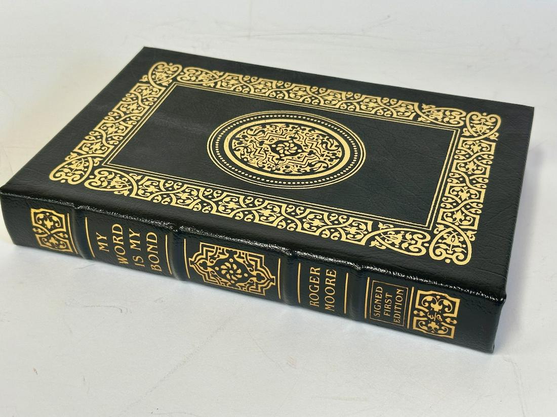 My Word is My Bond, Roger Moore - Sgd. First Edition; Easton Press: Dark gray leather bound, 2008. Most books in this collection are in Unused Condition. Some have minor flaws from sitting on book shelves that we'll show when photographing if significant enough.