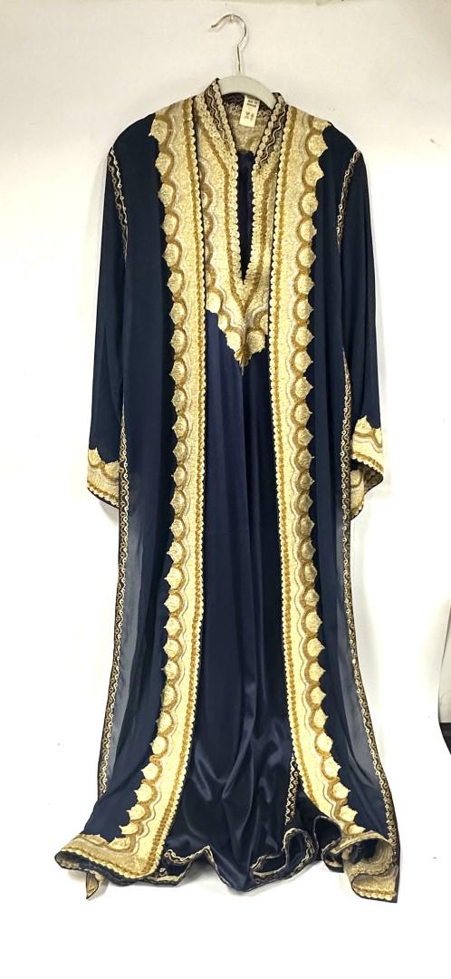 Moroccan Gilt Decorated Full Length Caftan: With ankle length or full length sleeveless dress ornately decorated in gilt beading and embroidery and overdress or caftan also ornately decorated in gilt beading and embroidery. Has a belt.