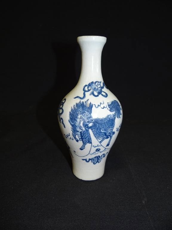 CHINESE PORCELAIN VASE: Painted in blue and white with a kilin and with Buddhist emblems. Leaf mark. 7 1/4"H.