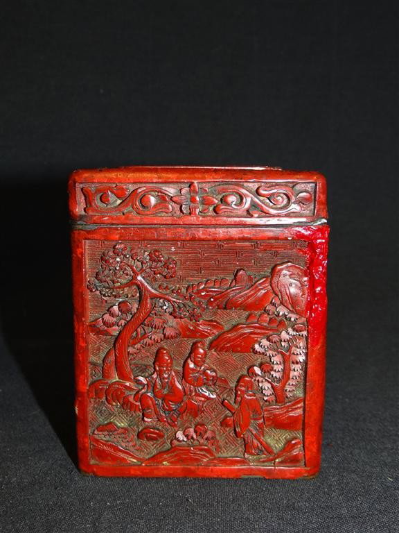18TH C. CHINESE CINNABAR BOX: Elaborately carved cinnabar box with brass interior. Carved landscape with figures; 4in. H. x 3.25in. W.