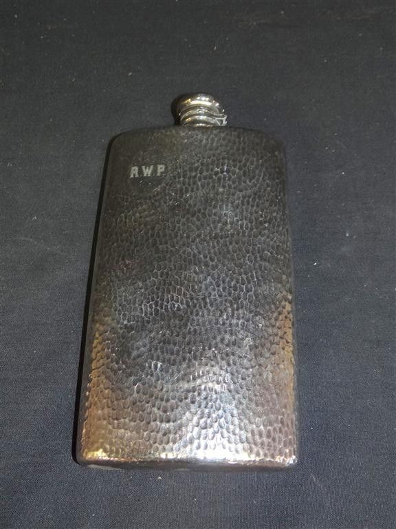 MERIDEN POCKET FLASK STERLING CAP: Hand hammered pocket flask with mark at the base for Meriden Co. International numbered 7123. Mark at the top Sterling Cap. Cartouche with initials 8 1/2"H. 5"W