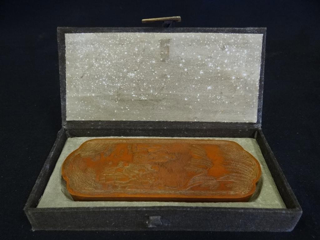 CHINESE INKSTONE: Red inkstone with incised decorations. 5 3/4" x 2"