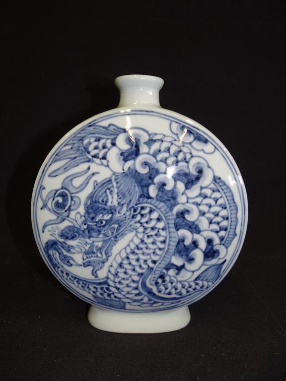 KOREAN MOON FLASK VASE: Decorated in blue and white dragons and bats. 8 1/4"H.