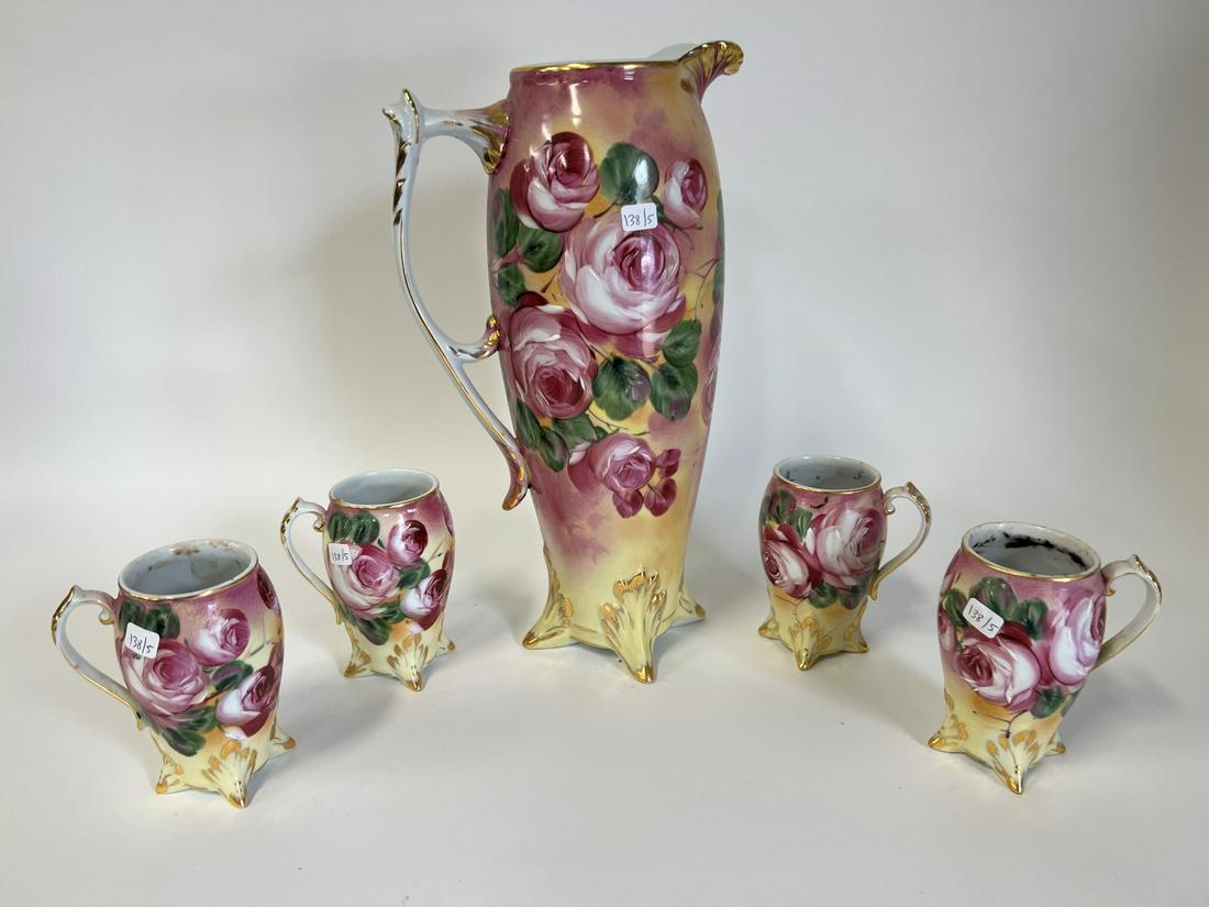 In the Manner of Limoges Beverage Set ( 5 pcs.): Serving pitcher and four tumblers. Hand painted floral designs.