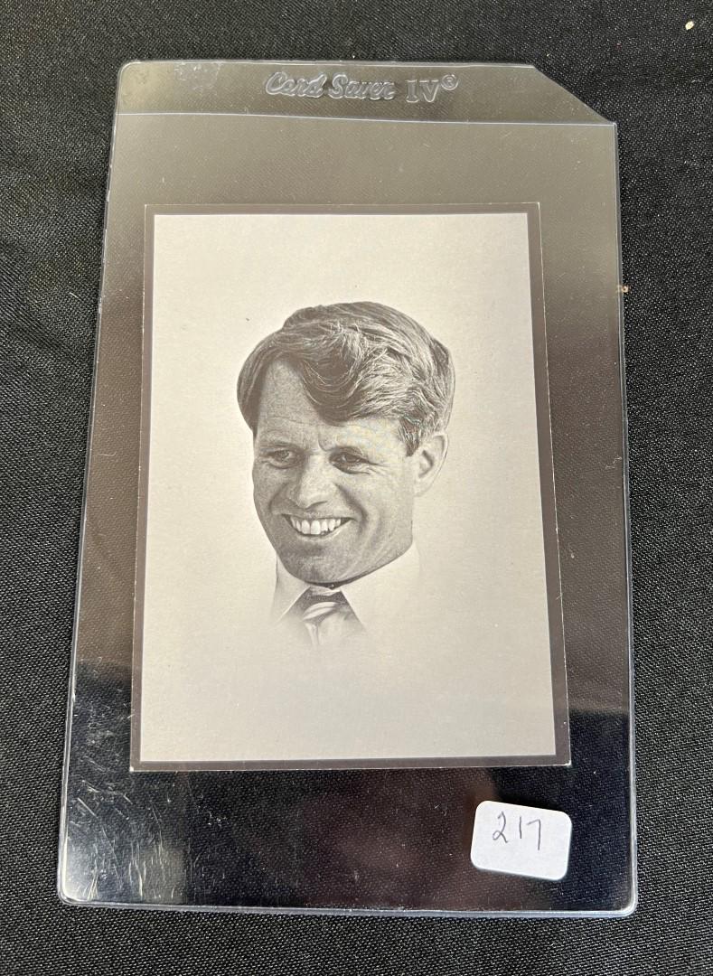 Robert Kennedy Mass Card: June 6 1968 with extemporaneous remarkd made by RFK at the funeral of Martin Luther King at the backside 4 1/2 x 3 1/2 In a heavy plexiglass protective sleeve