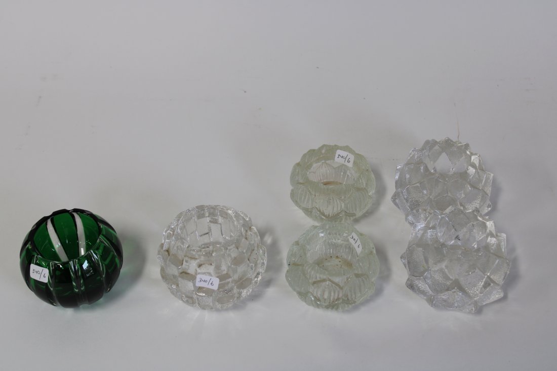 Lot of Votive Holders. inc. Kosta Boda, Faberge (6): Green glass marked Faberge; Kosta Boda marked; pr. marked at the underside Of and a pr. of Bohemia, Czech Republic, both with labels Six in the lot. Varying sizes 3"H to 2 1/4"H.