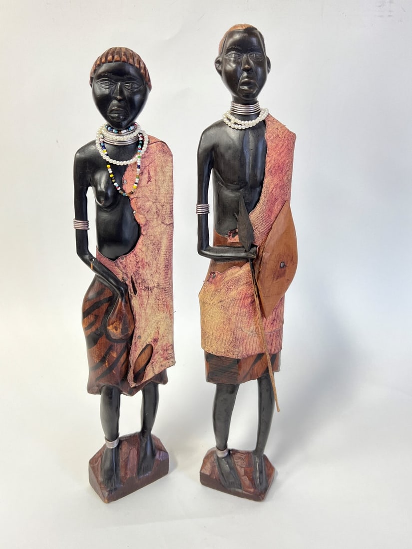 Pr. African Wood Carvings, Adorned (2): African carved wood figure, a man and a woman, adorned with pearls and beads and anklets and necklaces of silver. 21 1/4"H