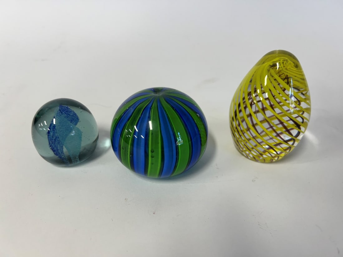 Collector or Dealer's Lot of Paperweights(3): Art Glass, blue and green stiped; a swirled yellow art glass, egg shape; and a signed miniature art glass paperweight, extensive signature but diffiicult to discern. Three in the lot. Tallest 4" H and
