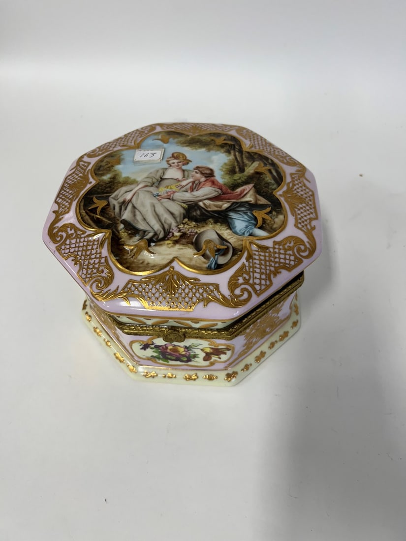 Porcelain Box: Hinged with gilt trim. Floral paintings and imagery of a man and woman. 5"H x 8"diameter