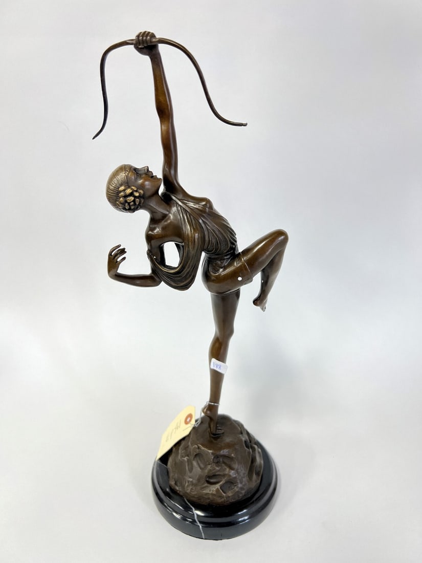 In the Manner of Le Faguays Nouveau Bronze: Art Nouveau woman with a bow on a bronze base resembling earth on marble. 20"H Signed Pierre Le Faguays.
