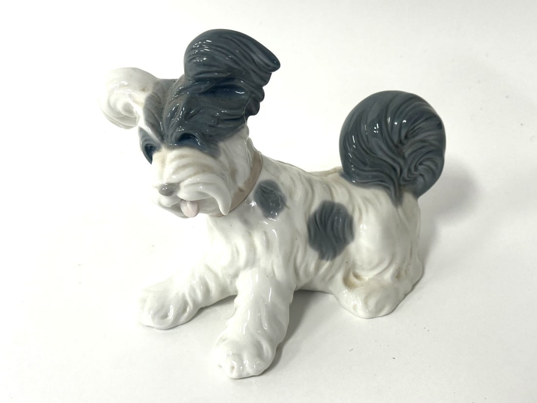 Lladro Porcelain Figure of a Skye Terrier: Hand painted porcelain figure of a Skye Terrier puppy. Marked at underside; 6in.H. x 7in.W.