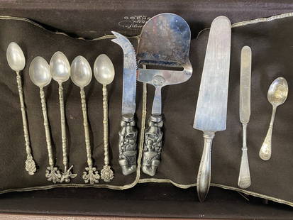 Large Lot of Vintage Silver Plate (49 pcs) & Fitted Chest: Included in the lot are two bas relief Christmas decorated servers wtih Sants's boots, bells, and wrapped gifts; five very ornate ice tea spoons decorated with fleur de lis, cherubs etc.; a Rogers