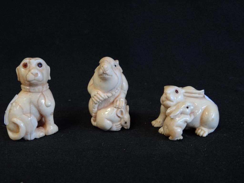 Three Carved Ivory Netsukes: An intertwined pair of rabbits; a pair of mice or rats and a dog. 1 1/4" to 2 1/4"
